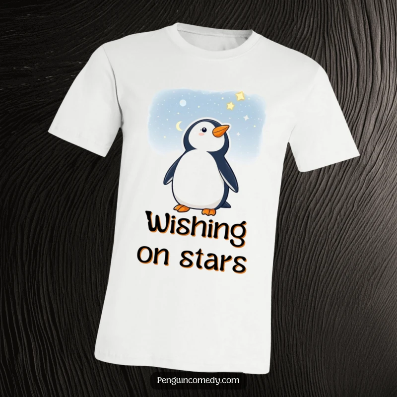 Funny t-shirt featuring a penguin looking up at a vast starry night, perfect for dreamers.
