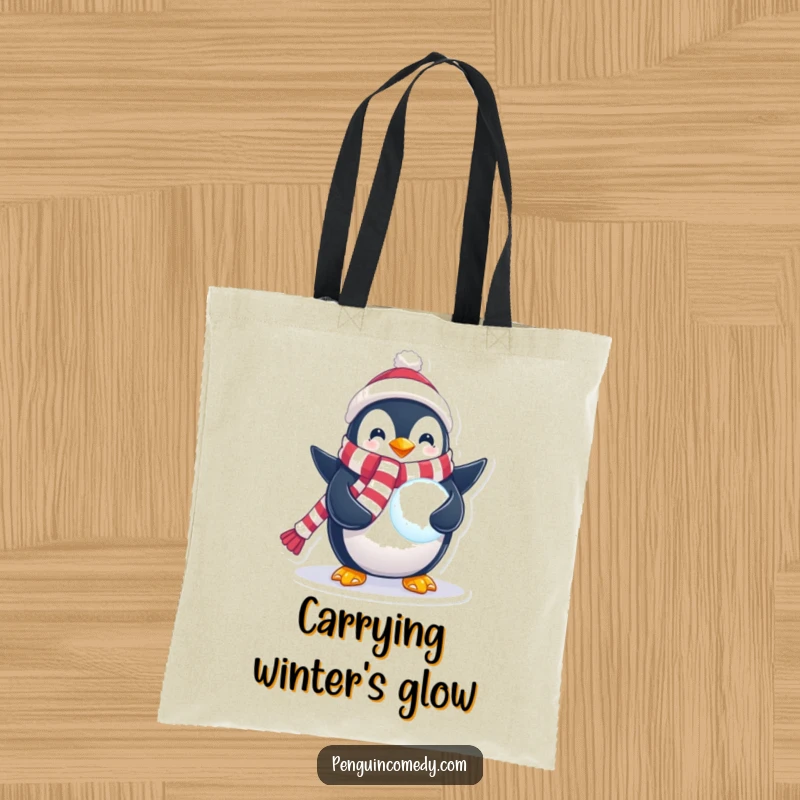 Funny Penguin Tote Bag showcasing a penguin in a festive scarf holding a glowing snowball, perfect for errands and carrying items with winter magic.